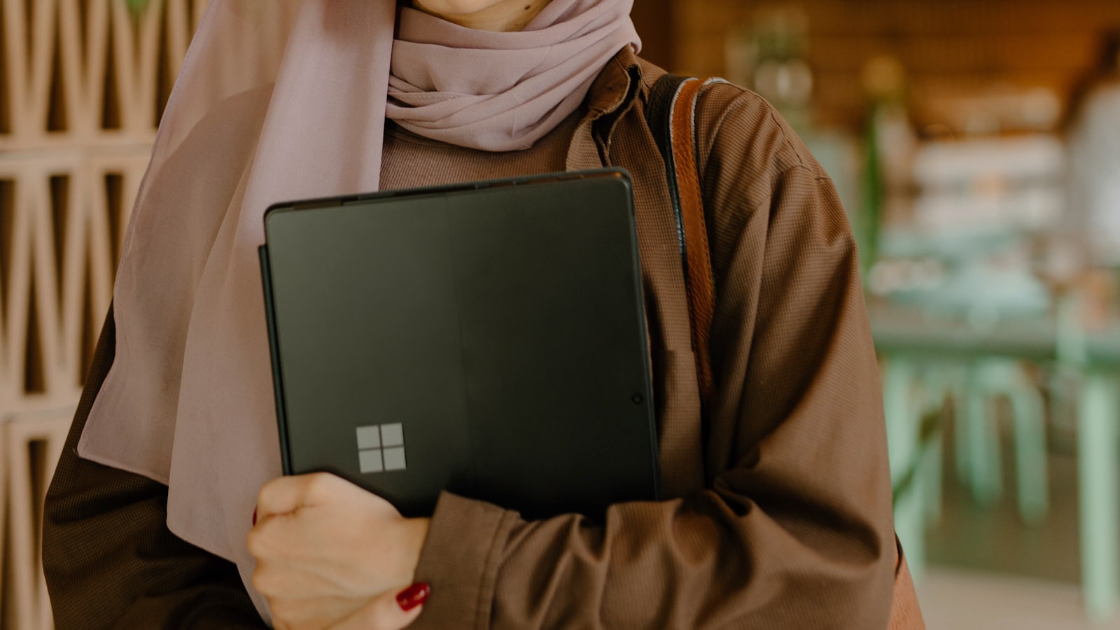 A person sitting at a desk reviewing notes on a laptop before an interview